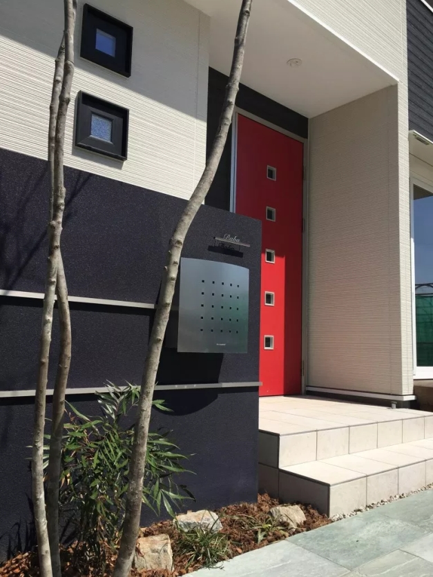 深紫の門柱にシンプルなデザインのポスト